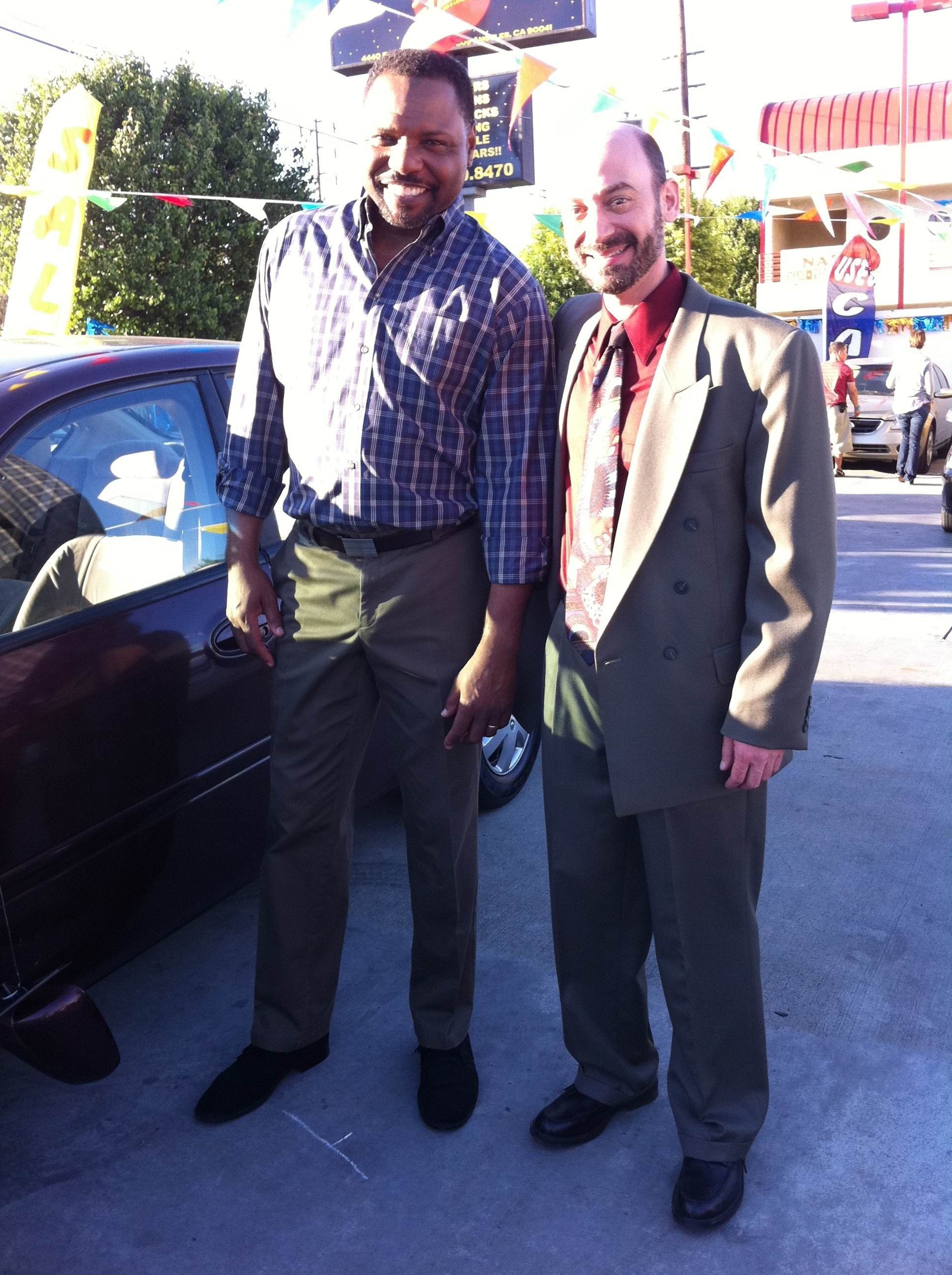 Actor Jeff Blumberg on set shooting a TV commercial, playing the role of a used car salesman